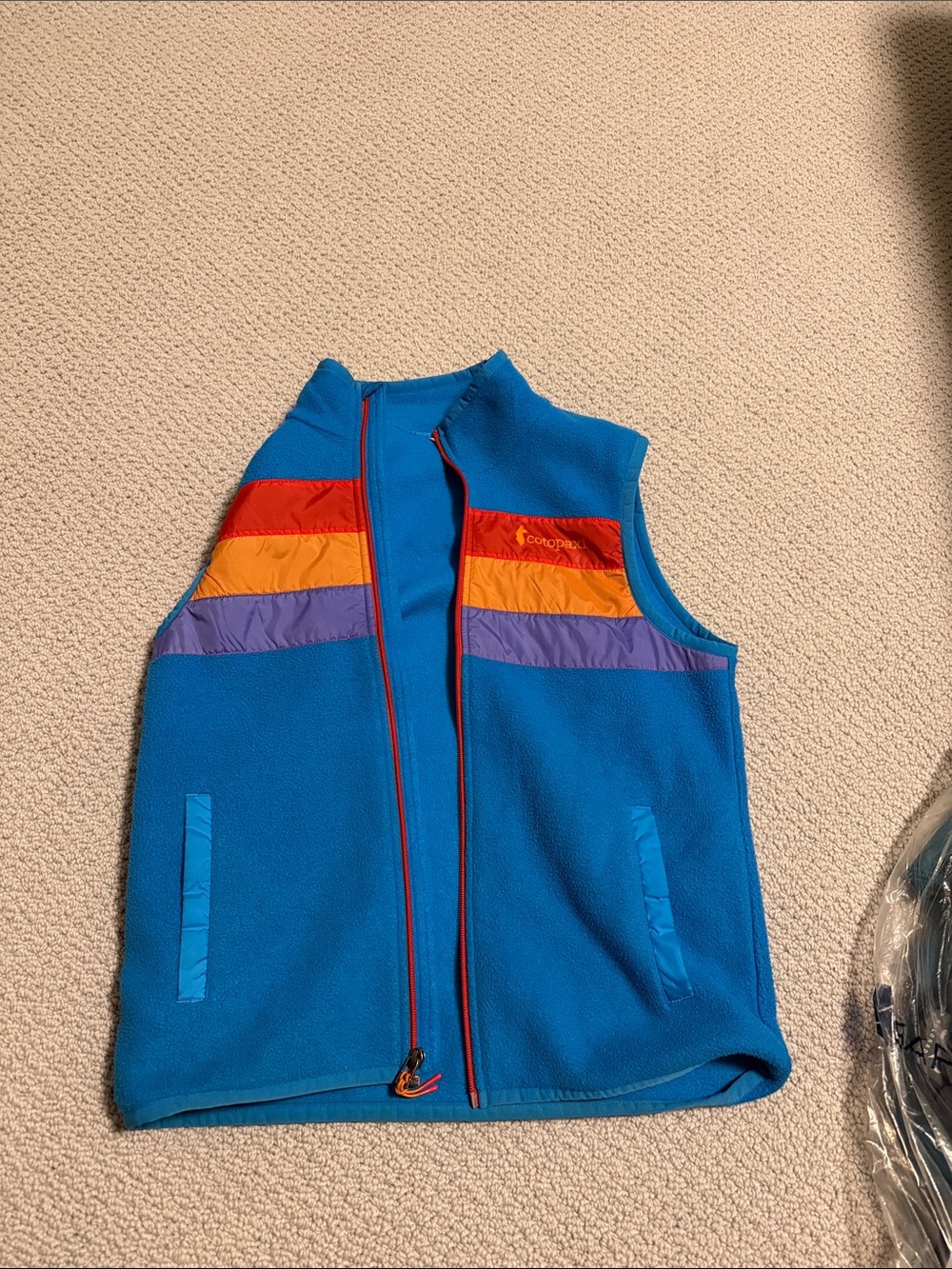 cotopaxi Blue men’s Fleece Vest with Red, Orange & Purple Chest Stripes